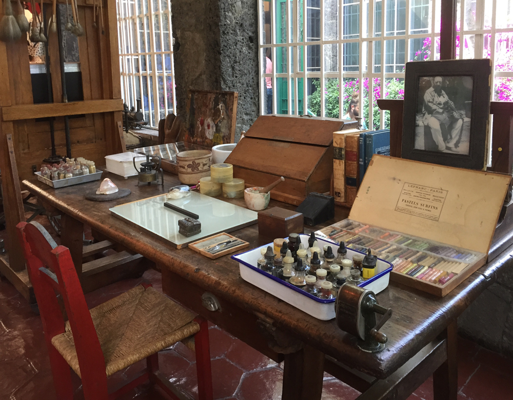 table with paints and materials at frida kalho's studio at casa azul, mexico