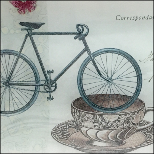 bike, cup, postage stamp and flower decoupage glass dish closeup