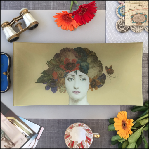 oblong glass decoupage dish with collage image of woman's face with flowers in her hair